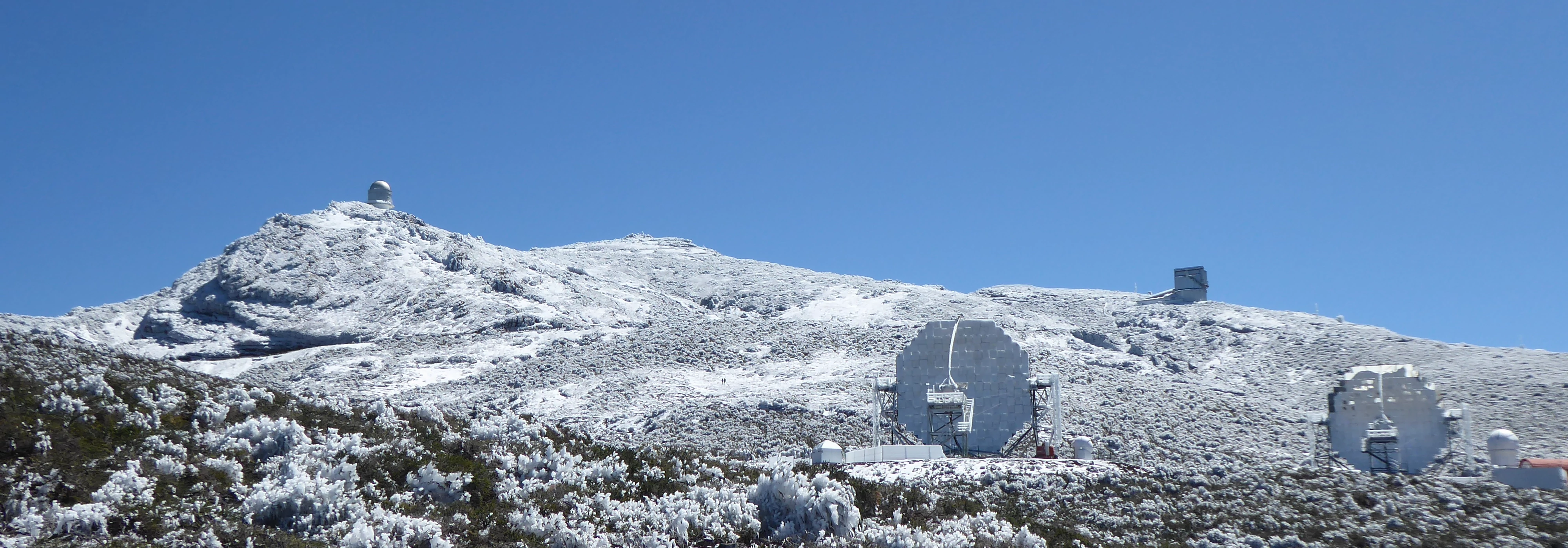 Telescopes at Roque de Los Muchachos, snow has fallen at the mountaintop.